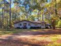 Cozy ranch home surrounded by lush greenery and tall trees at 400 Murray Blvd, Summerville, SC 29483
