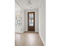 Bright entryway with hardwood floors and a rich wood front door at 519 Eagleview Dr, Moncks Corner, SC 29461