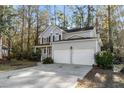 Two-story house with gray siding, two-car garage, and landscaped yard at 1045 Shinnecock Hills Ct, Summerville, SC 29483