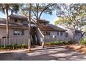 Gray townhome with mature trees and a fenced yard at 1240 Creek Watch Trce, Seabrook Island, SC 29455