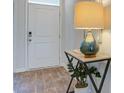 Bright entryway with a white door, wood-look floors, and a stylish table lamp at 135 River Hill Rd, Goose Creek, SC 29445