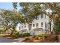 Two-story home with a two-car garage and lush landscaping at 2606 Cameron Blvd, Isle of Palms, SC 29451