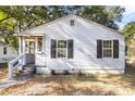 Renovated light gray house with black shutters, a porch, and well-maintained landscaping at 2720 W Surrey Dr, North Charleston, SC 29405