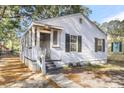 Front view of a charming renovated house with a porch and black shutters at 2720 W Surrey Dr, North Charleston, SC 29405
