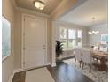 Elegant dining room with hardwood floors, chandelier, and a view to the backyard at 470 White Magnolia St, Moncks Corner, SC 29461