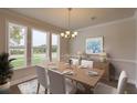 Bright dining room featuring a wooden table, white chairs, and large windows at 470 White Magnolia St, Moncks Corner, SC 29461