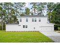 Rear view of a two story white house with a two car garage at 5655 Captain Kidd Rd, Hollywood, SC 29449