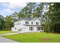 Two-story white house with gray roof and landscaping at 5655 Captain Kidd Rd, Hollywood, SC 29449