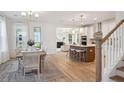 Open concept dining room with hardwood floors and access to kitchen at 769 Opal Wing St, Moncks Corner, SC 29461