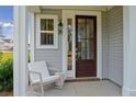 Inviting front porch with rocking chair and stylish front door at 769 Opal Wing St, Moncks Corner, SC 29461