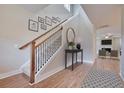 Bright entryway with hardwood floors, staircase, and view to living room at 8623 Connor Ct, North Charleston, SC 29406