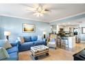 Open concept living room, kitchen, and breakfast bar at 9000 Palmetto Dr # 103C, Isle of Palms, SC 29451