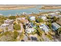 Aerial view of waterfront homes with private pools and lush landscaping at 109 Carolina Blvd, Isle of Palms, SC 29451