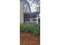 House side view, showcasing porch and landscaping at 1150 King St, Charleston, SC 29403