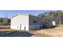 Rear view of a manufactured home showcasing gray siding and a back door at 120 Wilder Rd, Saint Stephen, SC 29479
