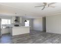 Open concept kitchen with island, stainless steel appliances, and wood-look floors at 120 Wilder Rd, Saint Stephen, SC 29479