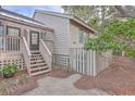 Exterior view of home with wooden stairs and fenced yard at 1248 Creek Watch Trce, Seabrook Island, SC 29455
