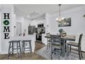 Modern kitchen with stainless steel appliances and adjacent dining area at 1300 Park West Blvd # 417, Mount Pleasant, SC 29466