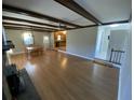 Living room with hardwood floors, exposed beams, and fireplace at 148 Ponderosa Dr, Ladson, SC 29456