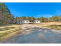 Single-story home with covered porch, long driveway and large yard at 150 Ridgemont Way, Summerville, SC 29486