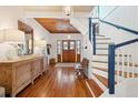 Bright and spacious entryway with hardwood floors and a grand staircase at 2256 Ion Ave, Sullivans Island, SC 29482