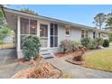 Side view of a ranch home with a screened porch at 229 Millcreek Dr, Charleston, SC 29407