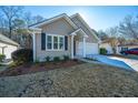 Tan house with dark shutters, attached garage, and neat landscaping at 2426 Tuscany Dr, North Charleston, SC 29406