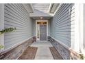 Front door entrance with stonework and gray siding at 306 Beachgrass Ln, Summerville, SC 29486