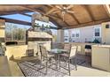 Relaxing outdoor kitchen and dining area with fireplace and TV at 320 Harry Ln, Moncks Corner, SC 29461