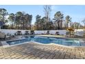 Inviting swimming pool with brick patio and tropical landscaping at 320 Harry Ln, Moncks Corner, SC 29461