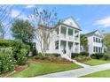 Two-story white house with a front porch and nicely landscaped yard at 3337 Ethan St, Mount Pleasant, SC 29466