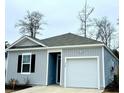 Newly built gray house with a white garage door and black shutters at 350 Feldspar Ln, Ladson, SC 29456