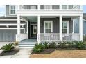 Inviting front porch with white railings and columns at 3687 Spindrift Dr, Mount Pleasant, SC 29466