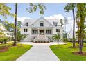 White two-story home with metal roof, and a circular driveway at 3908 Delinger Dr, Mount Pleasant, SC 29466