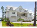 Two story white home with metal roof and landscaping at 3908 Delinger Dr, Mount Pleasant, SC 29466