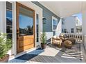 Inviting front porch with wooden door and comfortable seating at 3913 Maidstone Dr, Mount Pleasant, SC 29466