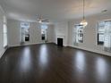 Open living room with dark hardwood floors and a fireplace at 4140 Home Town Ln, Ravenel, SC 29470