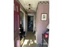 Home entryway with patterned wallpaper and cluttered floor at 4328 Helene Dr, North Charleston, SC 29418