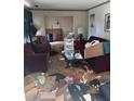 Messy living room with maroon couches and cluttered floor at 4328 Helene Dr, North Charleston, SC 29418
