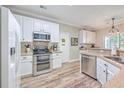 Modern kitchen with white cabinets, granite countertops, and stainless steel appliances at 602 Leaning Pin Ct, Summerville, SC 29485