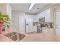 Modern kitchen with white cabinets, granite countertops, and stainless steel appliances at 602 Leaning Pin Ct, Summerville, SC 29485