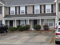 Two-story tan house with black shutters and multiple entrances at 8875 Jenny Lind St, North Charleston, SC 29406