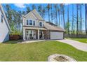 Two-story house with light beige siding, stone accents, and a gray door at 103 Oyama Rd, Summerville, SC 29486