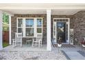 Charming front porch with rocking chairs and stone facade at 103 Oyama Rd, Summerville, SC 29486