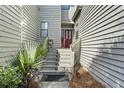 Inviting entryway with red door and steps leading to the home's entrance at 1031 Marsh Court Ln, Mount Pleasant, SC 29464