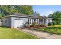 Gray house with a white garage door and red front door at 115 Three Wood Ln, Summerville, SC 29483