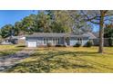 House exterior showcasing a gray siding and a well-maintained lawn at 115 Three Wood Ln, Summerville, SC 29483