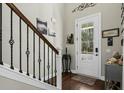 Foyer with staircase, hardwood floors, and decorative wall art at 123 Beam St, Huger, SC 29450