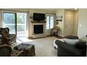Relaxing living room with fireplace, access to balcony, and lake views at 1481 Center Street Ext # 1808, Mount Pleasant, SC 29464