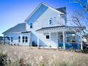 Two-story house with covered patio and grassy yard at 1573 Trailmore Ln, Summerville, SC 29486